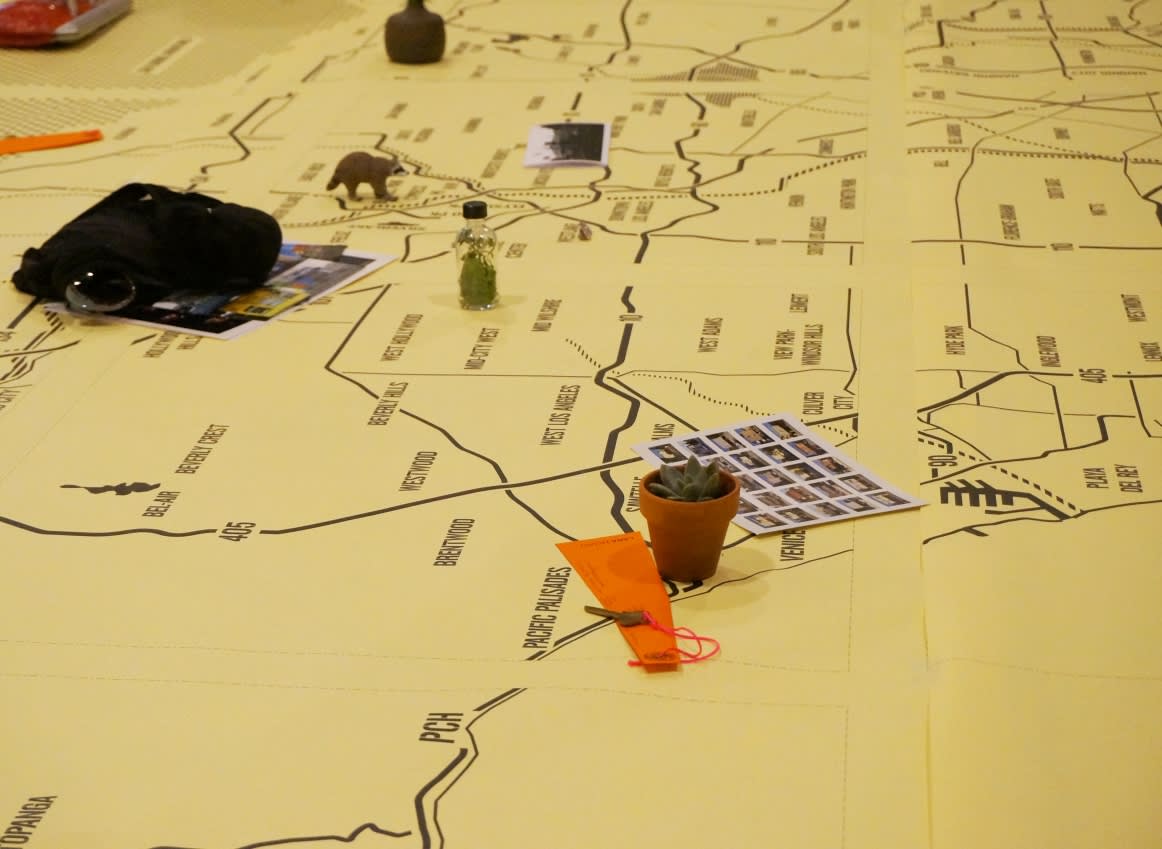 Guests seated around a giant map on a table detail