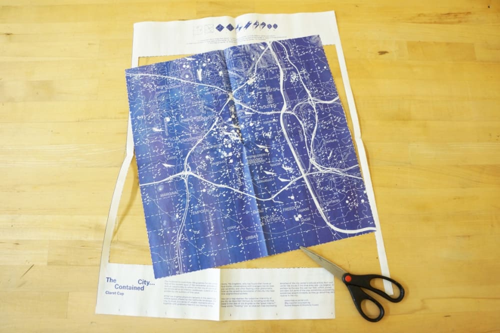 Newspaper centerfold with cutout and scissors