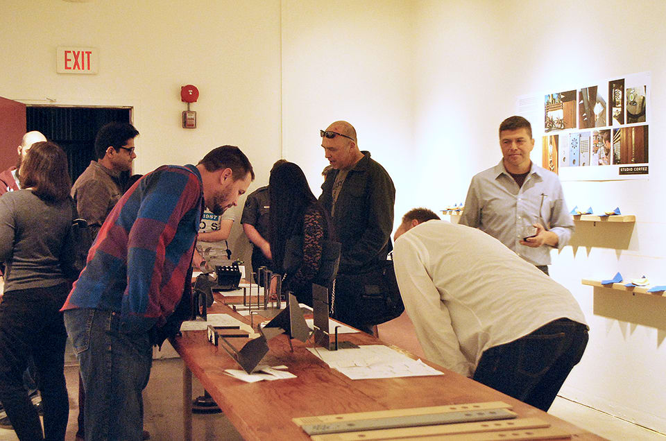 People looking at a vitrine in a gallery